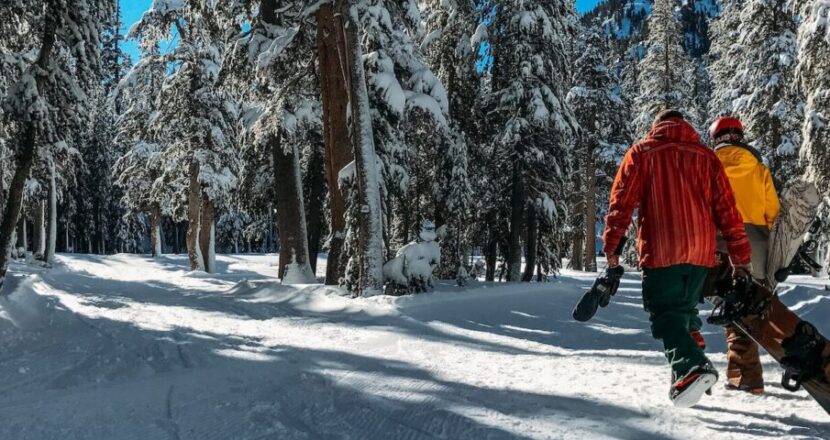 two men walking on snow