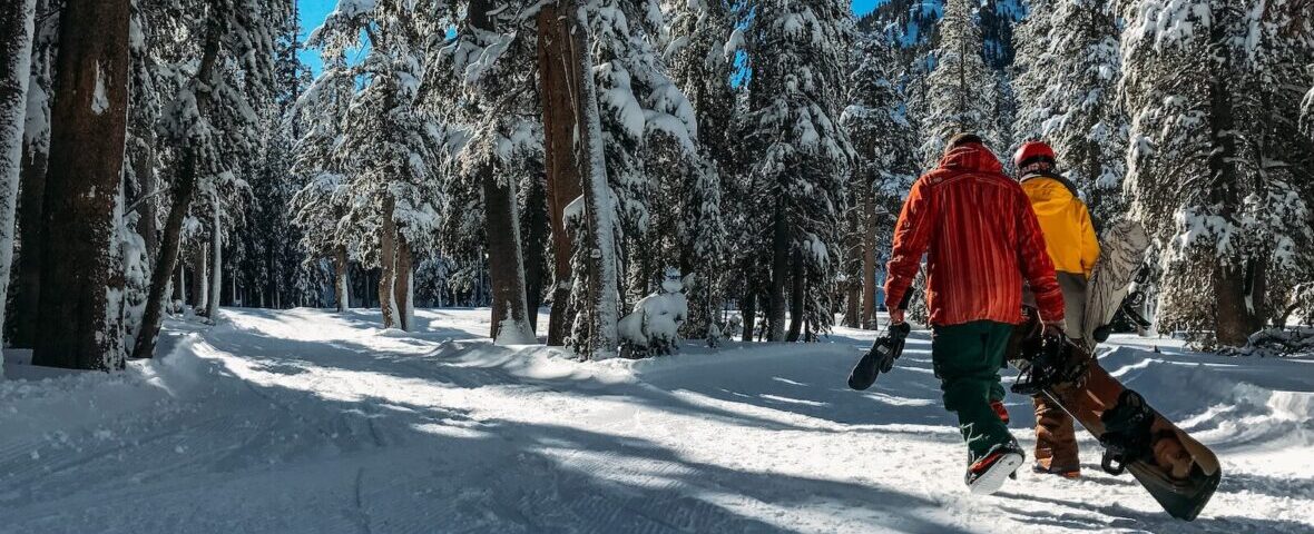 two men walking on snow